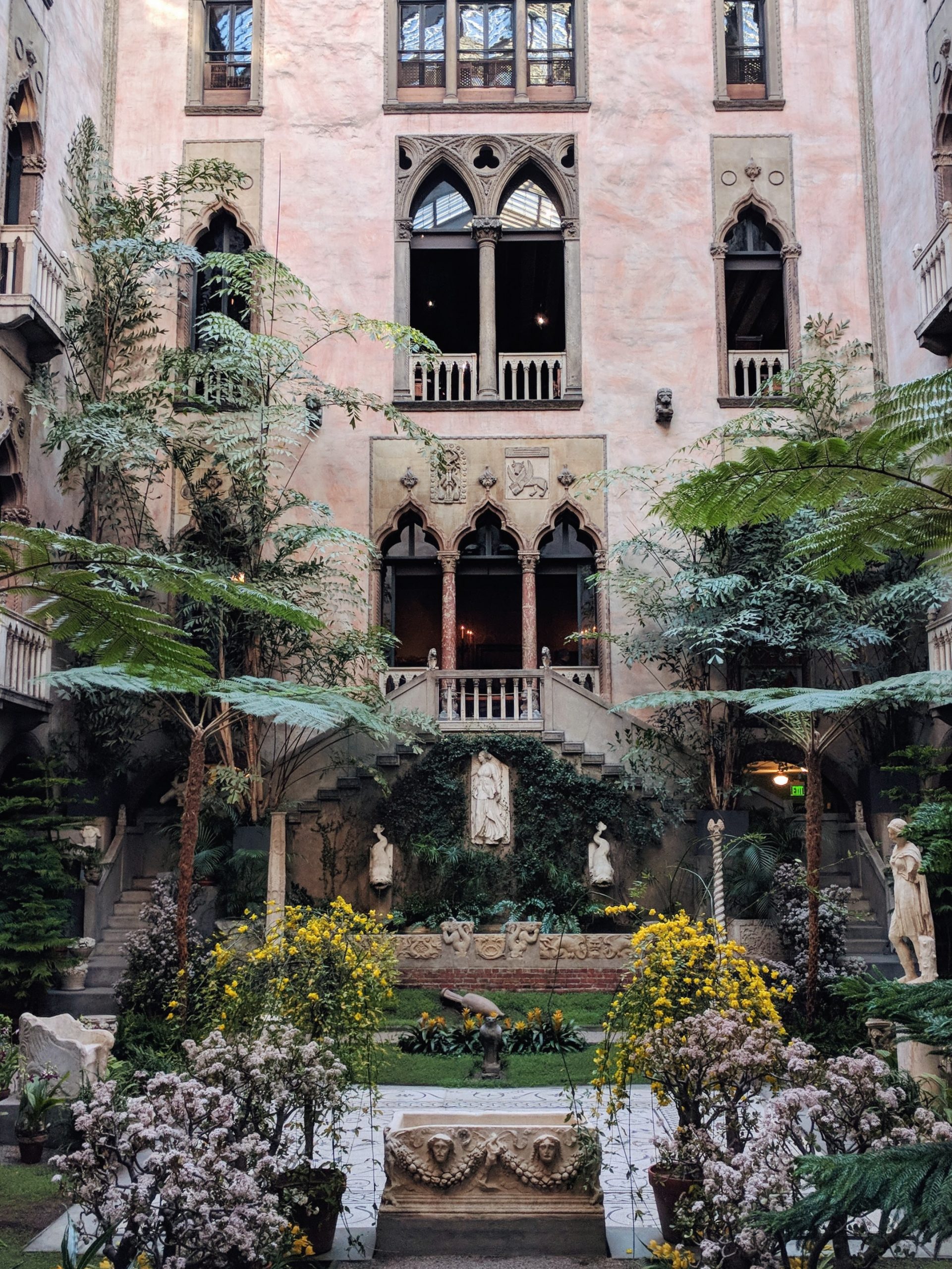 Isabella Stewart Gardner museum courtyard with lush green trees and plants