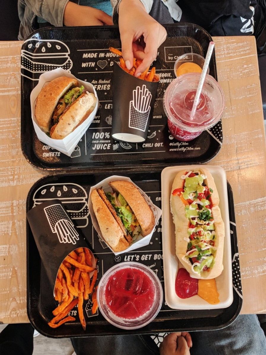 vegan burger and hot dog with fries and lemonade