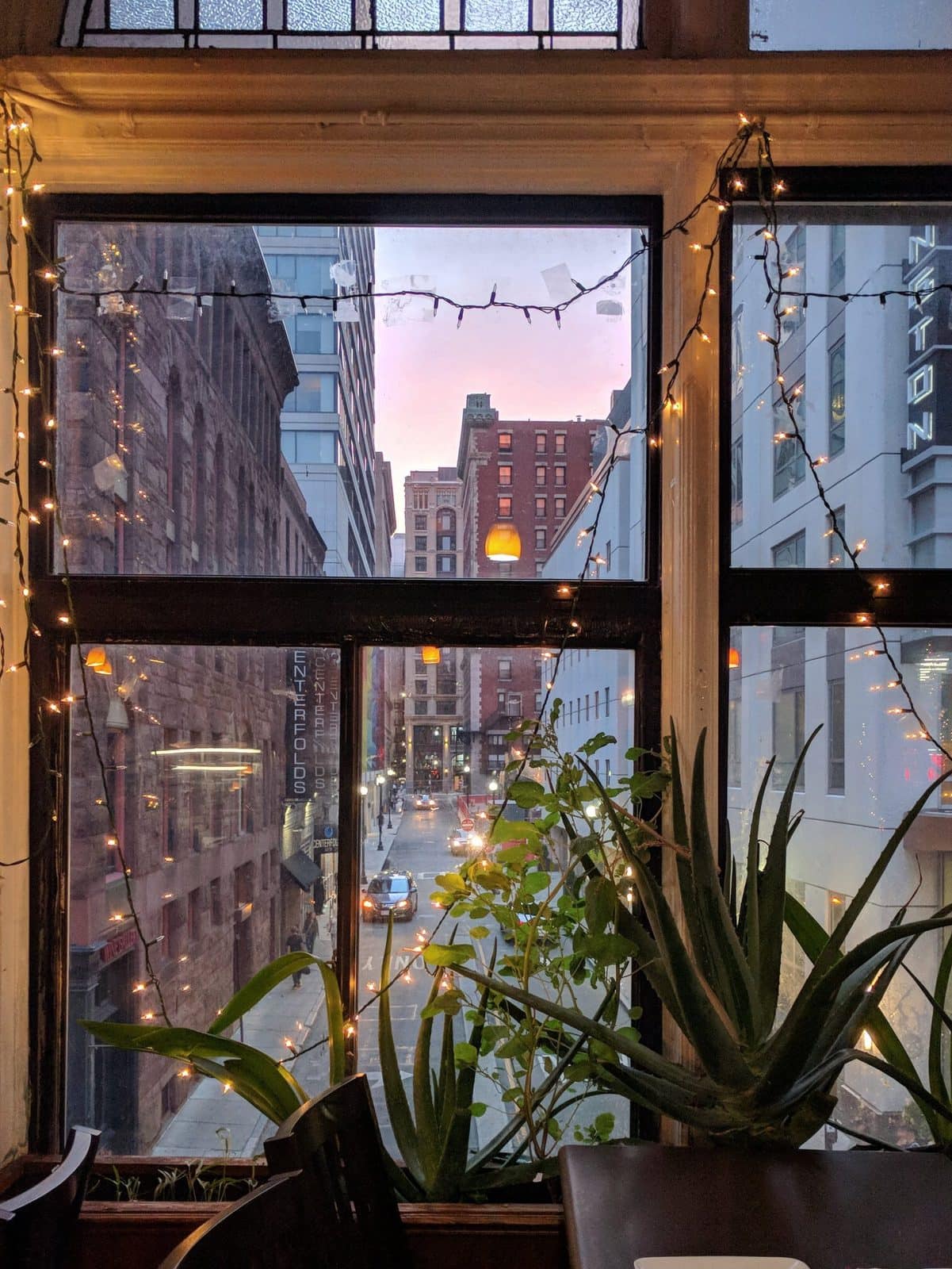 view of the city at sunset from a second floor window