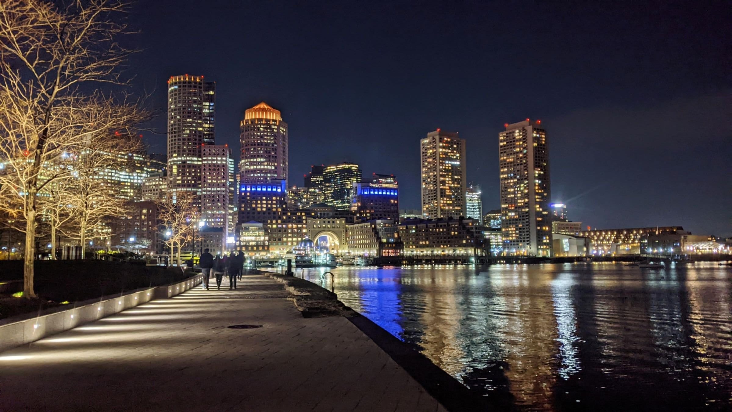 Boston skyline at night from Fan Pier Park at Seaport, with the reflection on the water