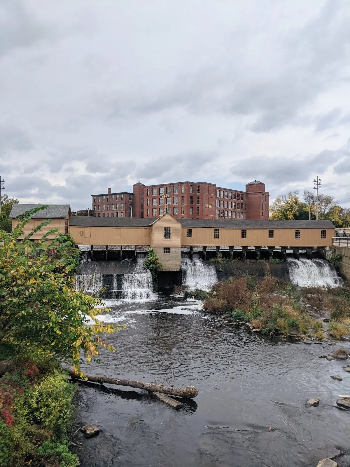 A covered bridge across a canal in Lowell, MA